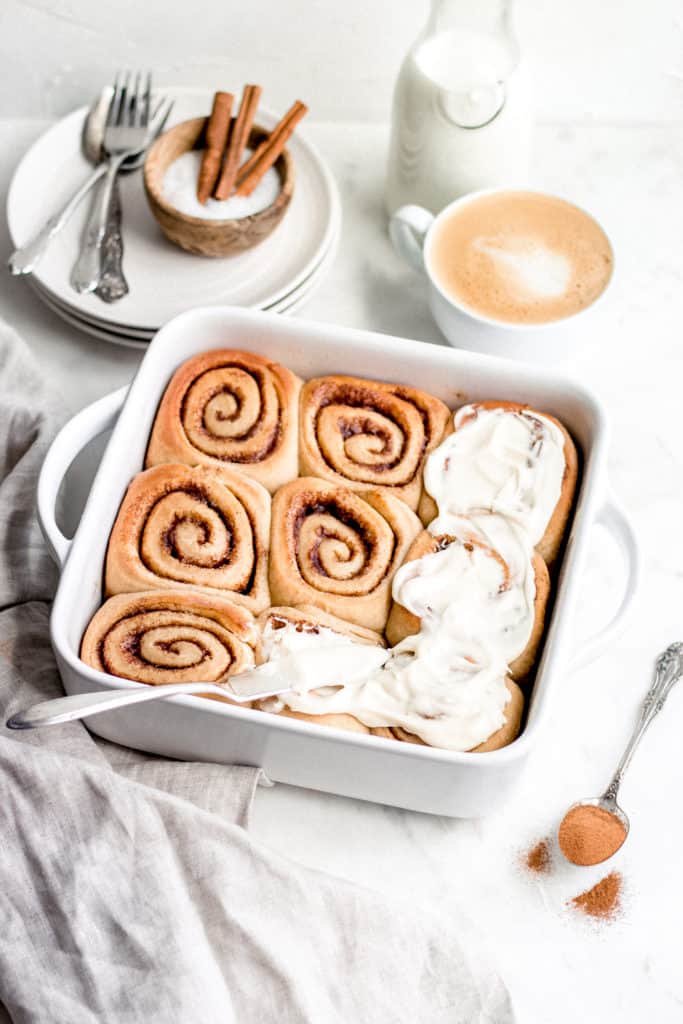 cinnamon rolls in pan with frosting