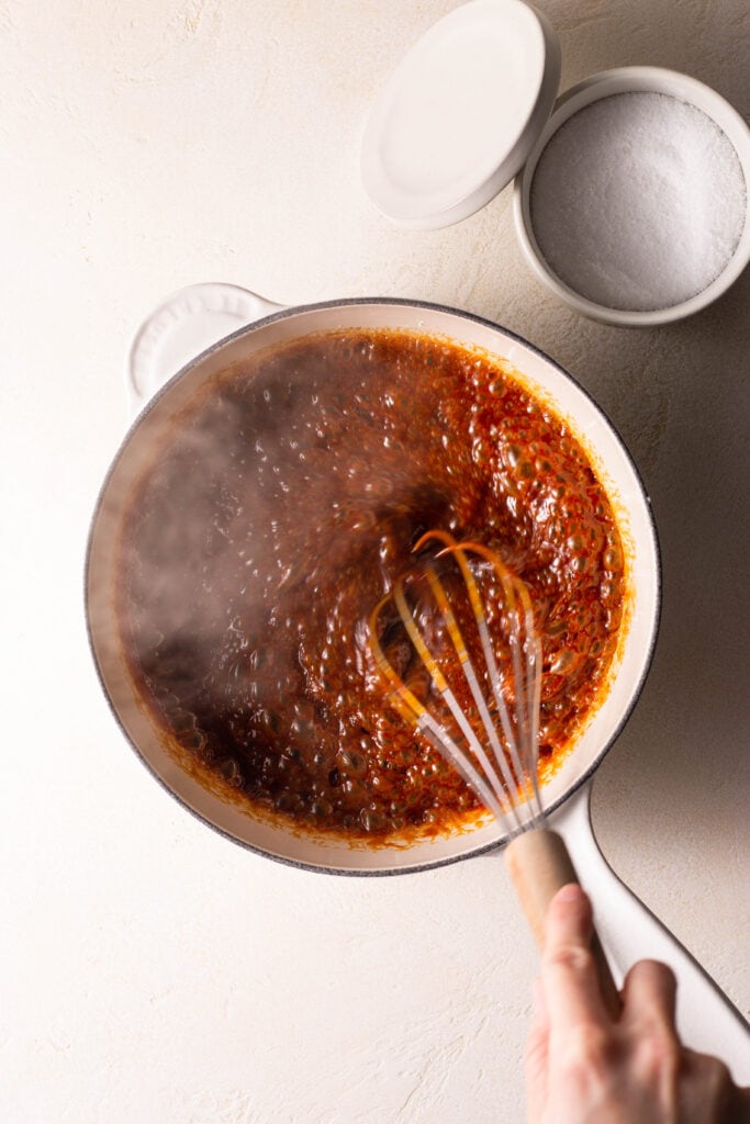 stirring the homemade caramel sauce in a saucepan