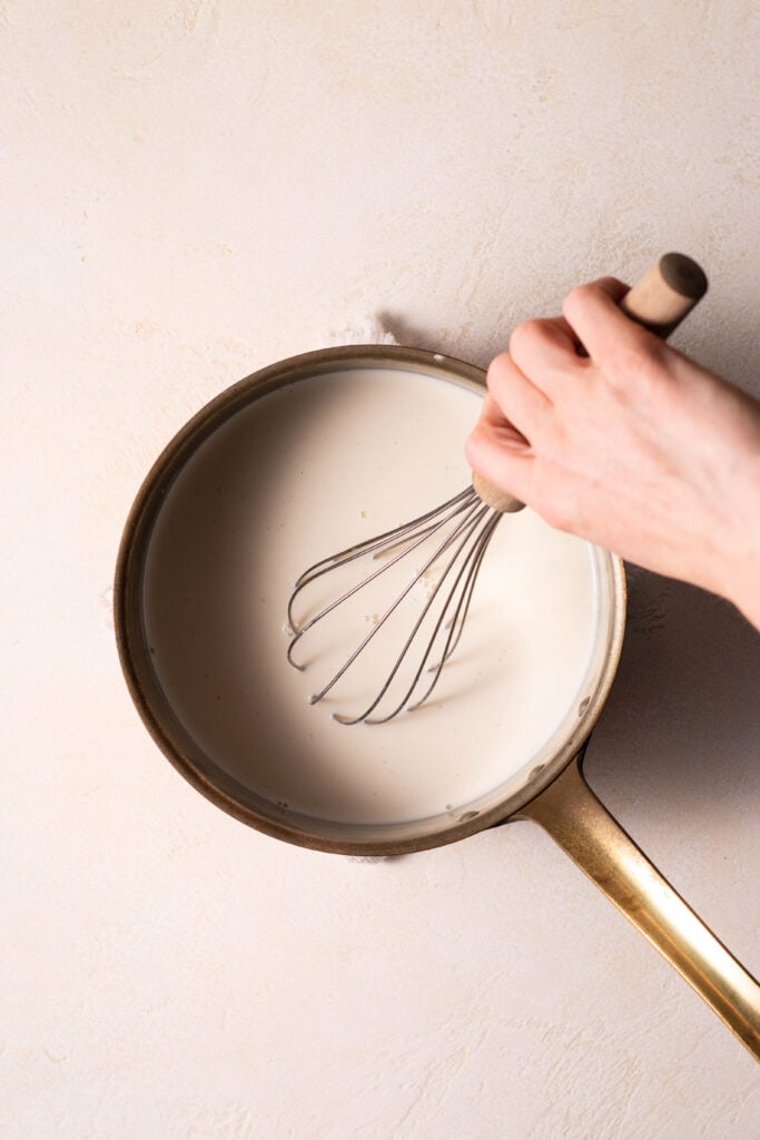 whisking milk in a saucepan