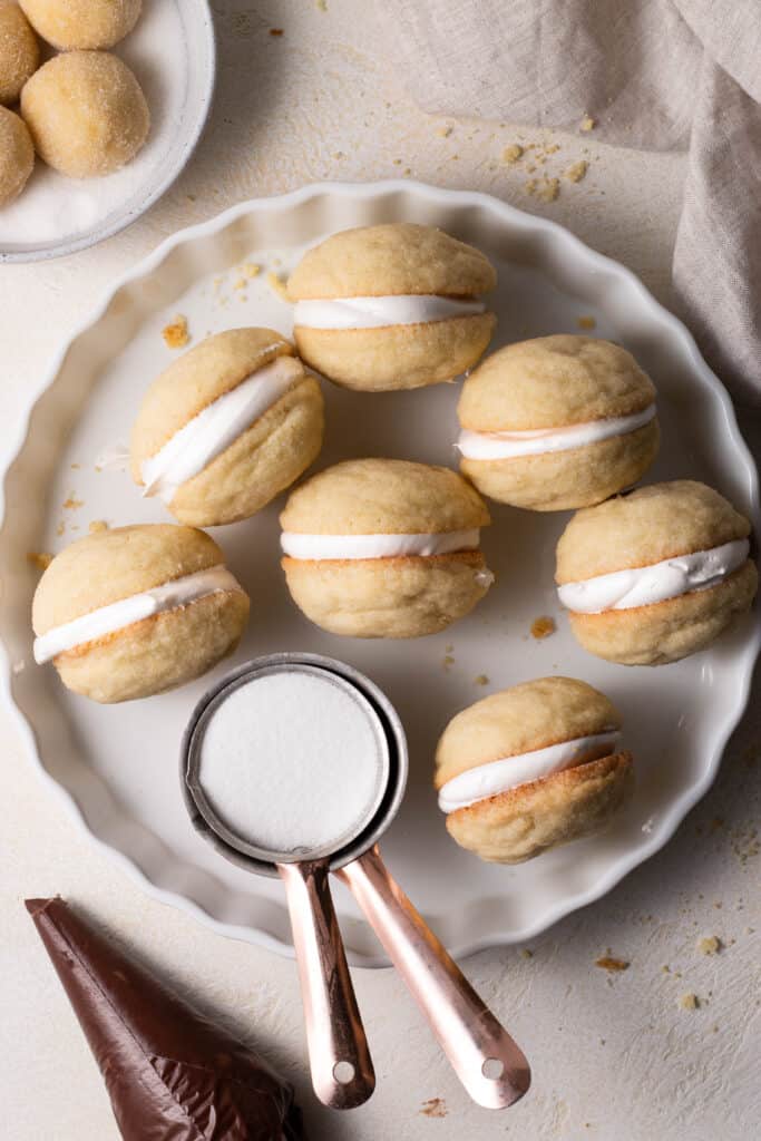 sugar cookie sandwiches on a pan with ganache