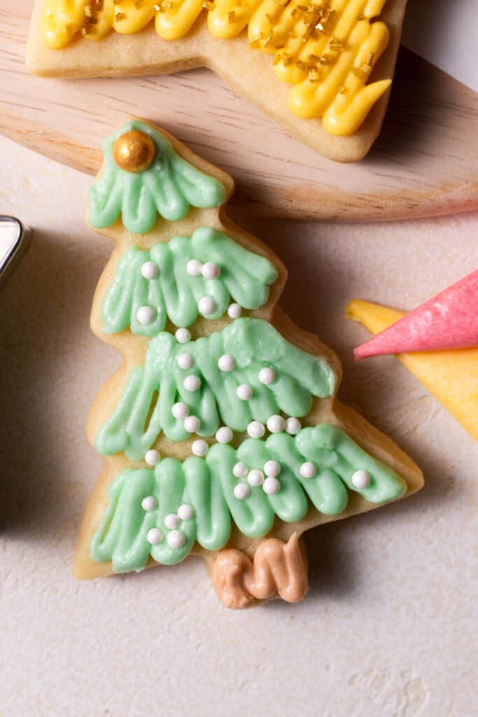 christmas tree sugar cookie cut-out on a board