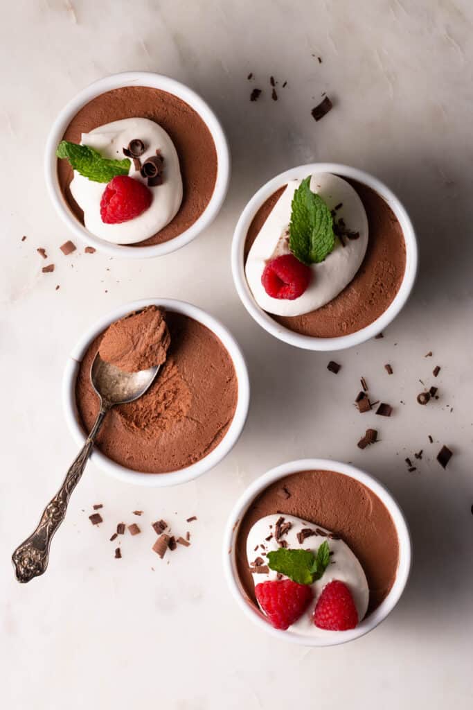 chocolate mousse in ramekins with various toppings