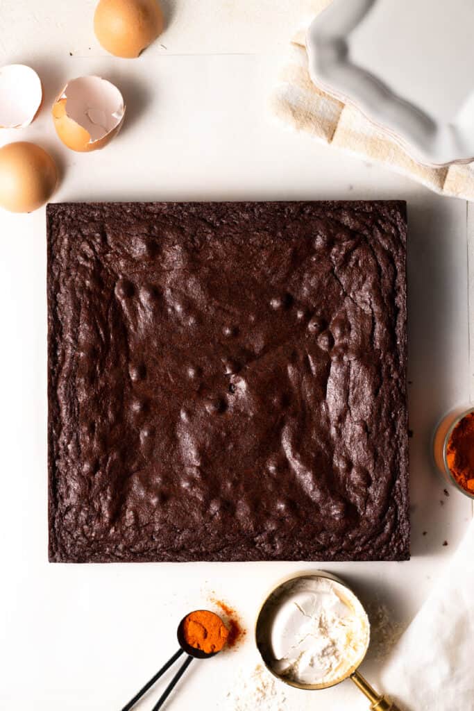 mexican brownies on a board with ingredients surrounding