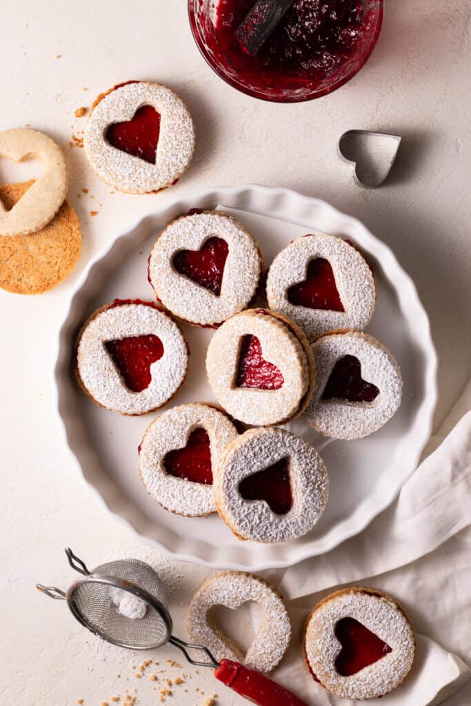 raspberry-pecan linzer cookies on a plate