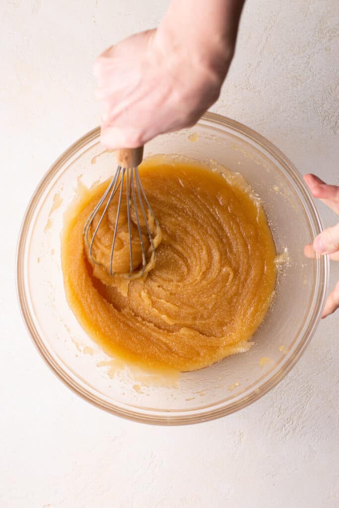 hand whisking ingredients together