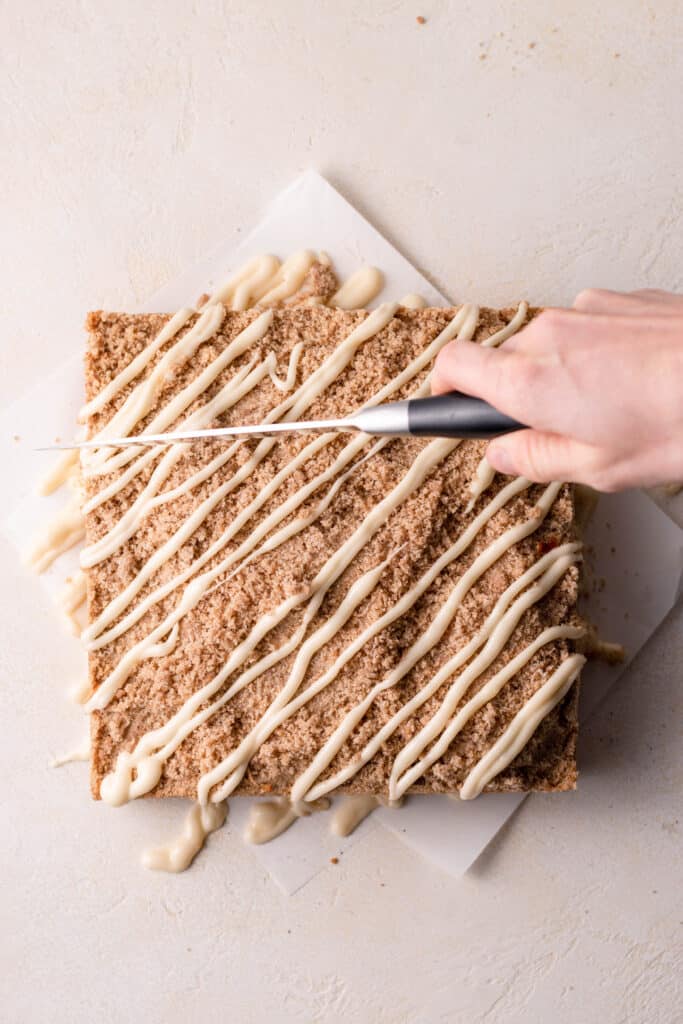 hand slicing coffee cake