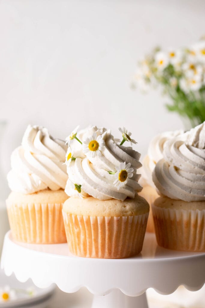 vanilla cupcakes with flowers in frosting