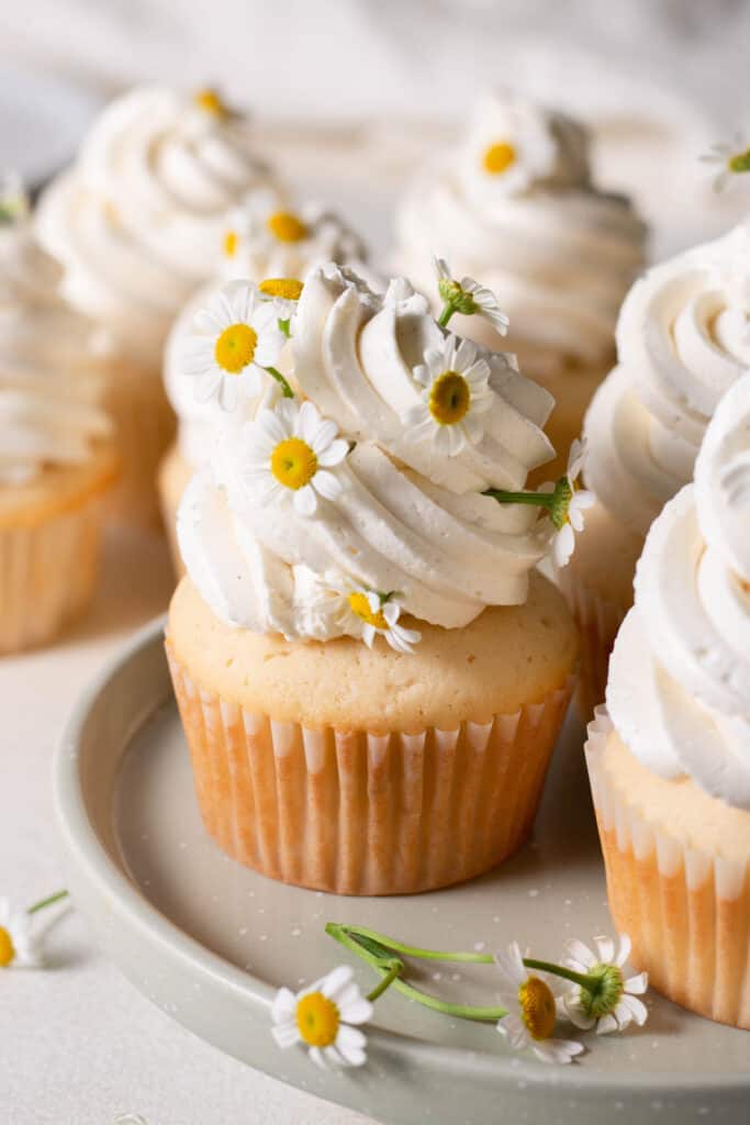 vanilla cupcakes with flowers in the frosting