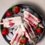 strawberry cheesecake popsicles on a surface