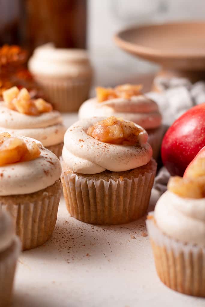 apple pie cupcakes on a board surrounded by decorations