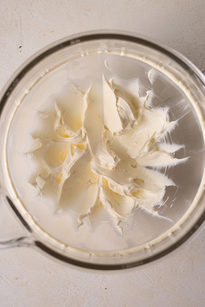 butter being beaten in a stand mixer bowl