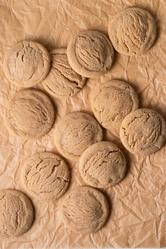 multiple brown sugar cookies on a piece of parchment paper.