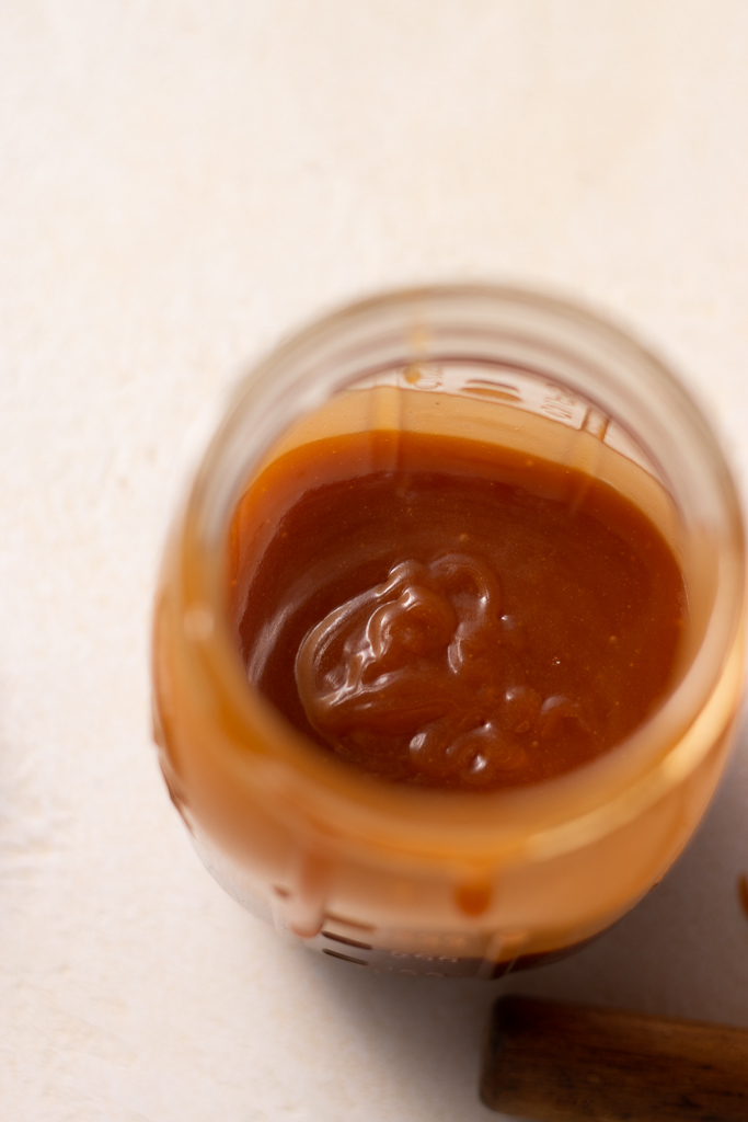 overhead shot of apple cider caramel sauce in a mason jar