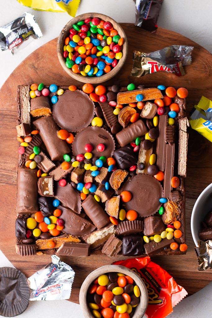 overhead shot of leftover halloween candy brownies on a board.