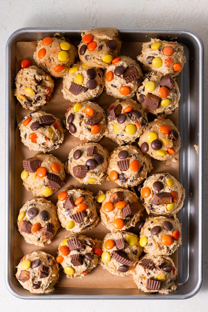 above shot of cookie dough balls on a sheet pan before they're baked.
