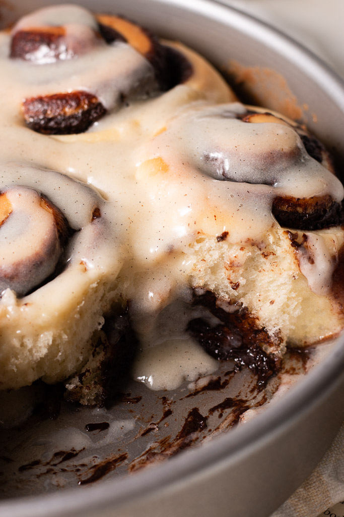 side angle of chocolate cinnamon rolls in a 9-inch pan with a few taken out of the pan so you can see the inside of a roll.