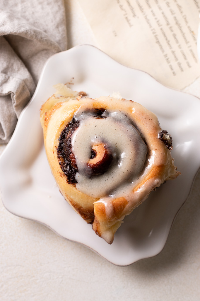 overhead shot of one chocolate cinnamon roll on a plate.