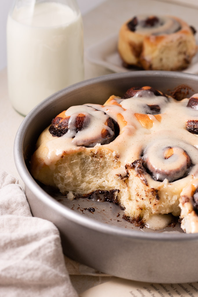 side shot of chocolate cinnamon rolls in a pan.