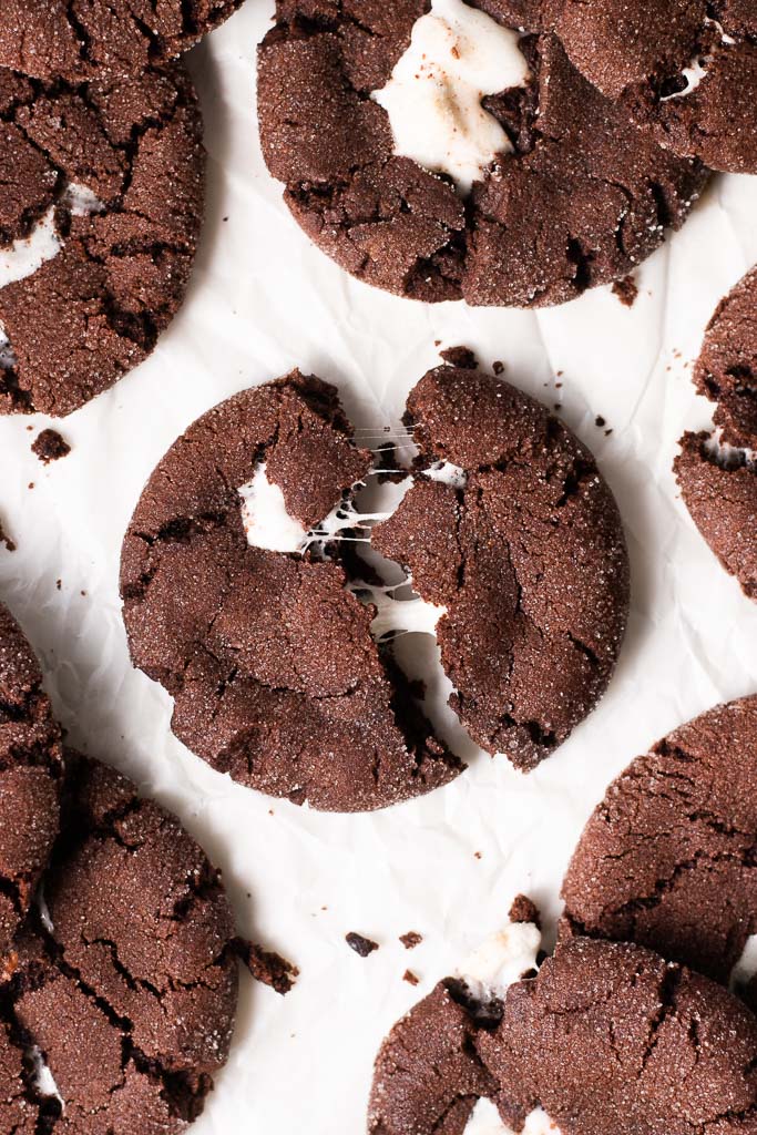 chocolate marshmallow cookie on a board and being pulled apart.