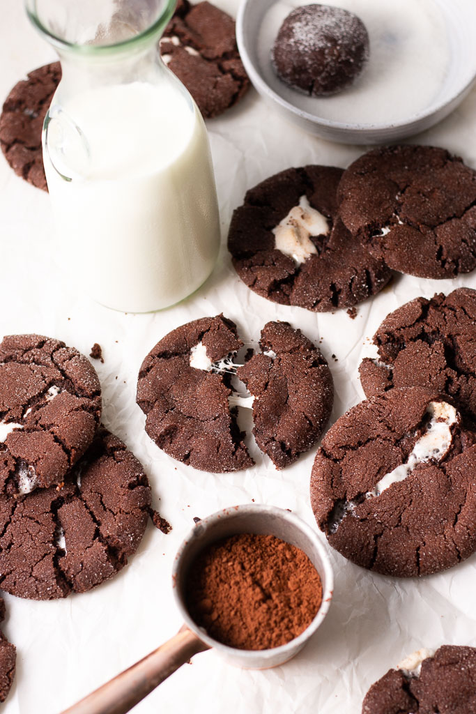 hot chocolate marshmallow cookies on a board shot at a 45 degree angle.