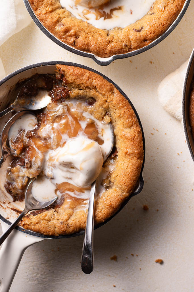 overhead shot of mini skillet cookies with caramel homemade caramel sauce.