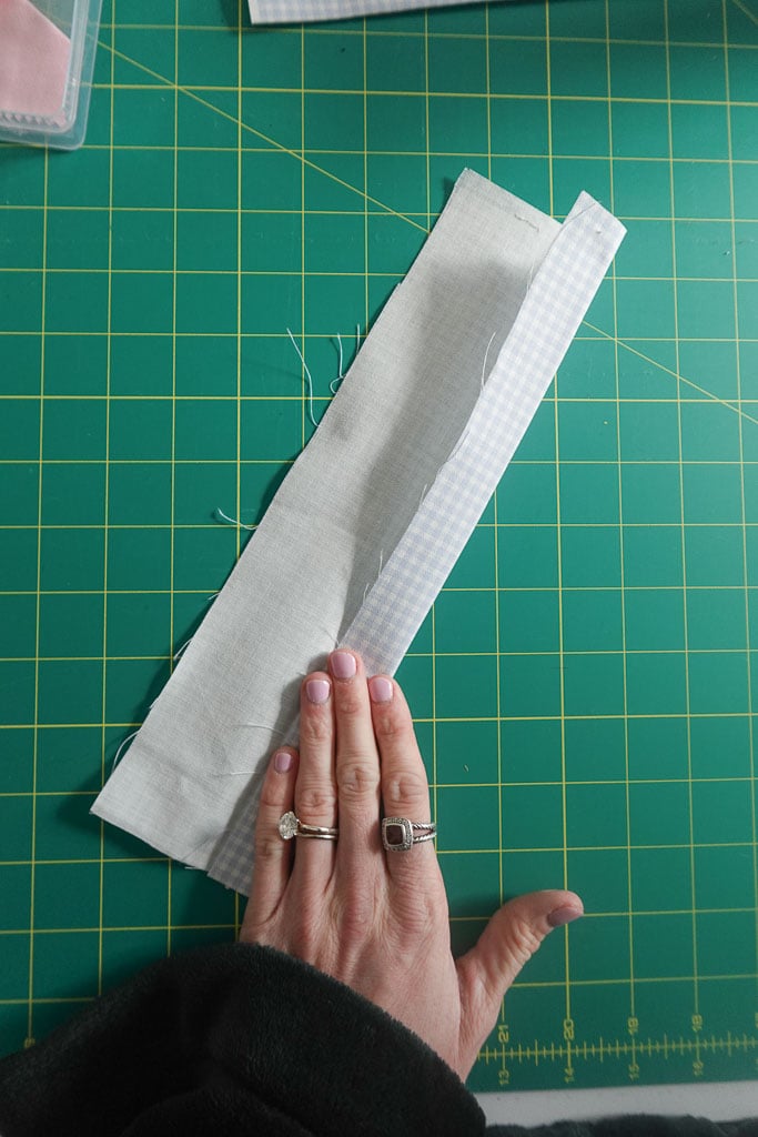 folding fabric edge in towards center fold.