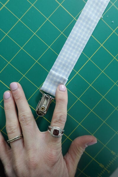 folding the raw edge under 1/4-inch.