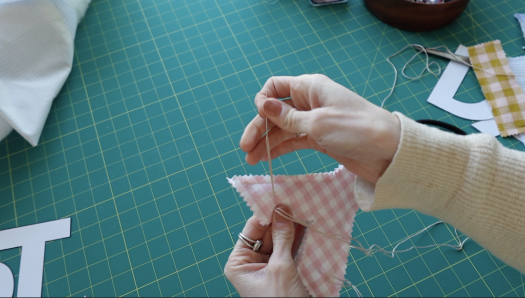 stringing it all together with embroidery floss.