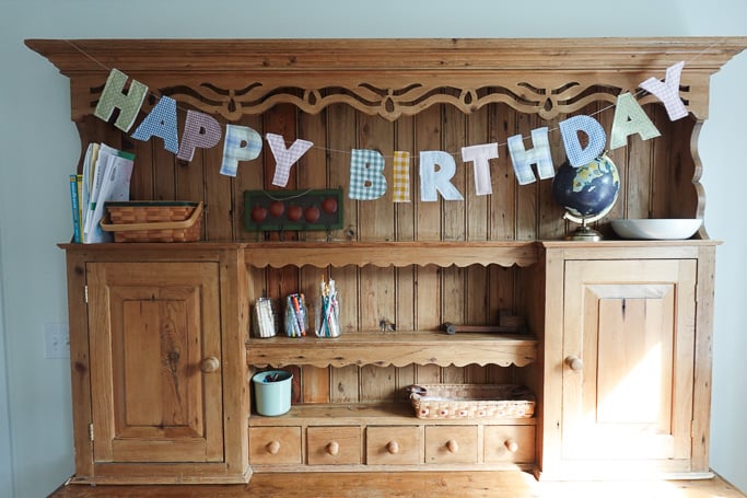 diy letter sign hanging on a hutch.